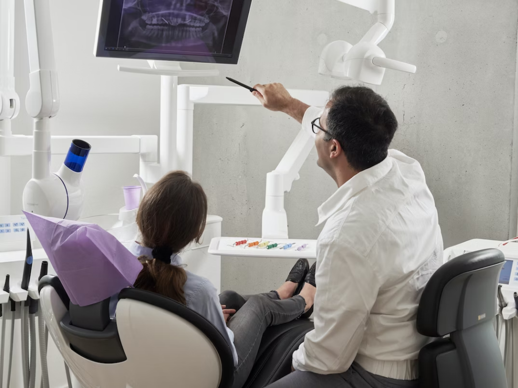 a dentist explaining the result of a dental x-ray to his patient