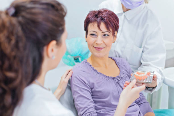 a patient smiling at the dentist while sitting on the dental chair