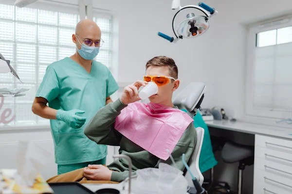 a patient gargling after a dental treatment