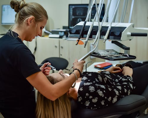a dentist performing a dental procedure on a patient